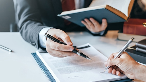 Pens pointing at information in a document