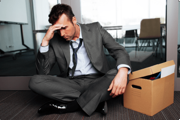 man sitting on the floor in a suit