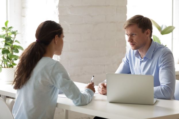 two people talking across a table