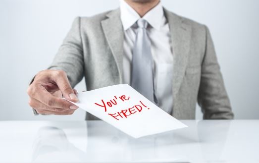 man in suite holding a sign