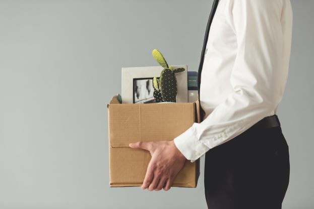 man carrying box in an office